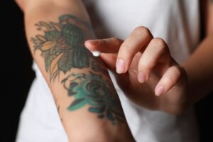 Woman Applying Cream On Her Arm With Tattoos Royalty Free Image 1683757586